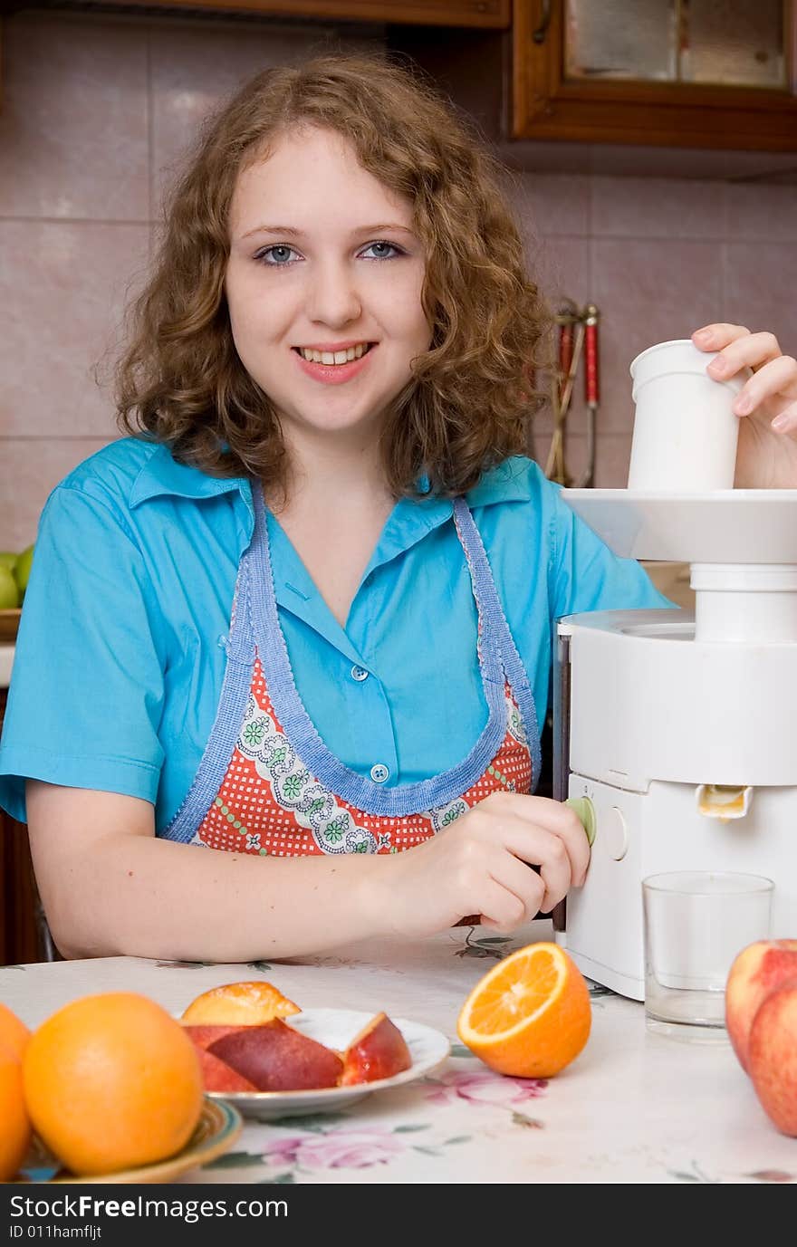 Girl with blender and fruits on home kitchen