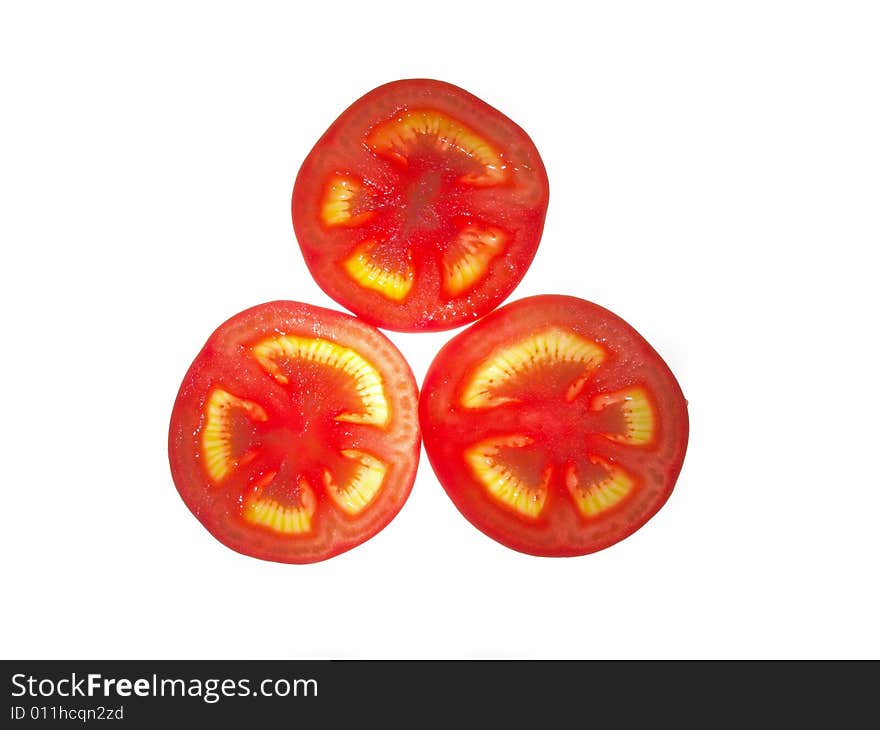 The ripe juicy tomato cut on a part on a white background