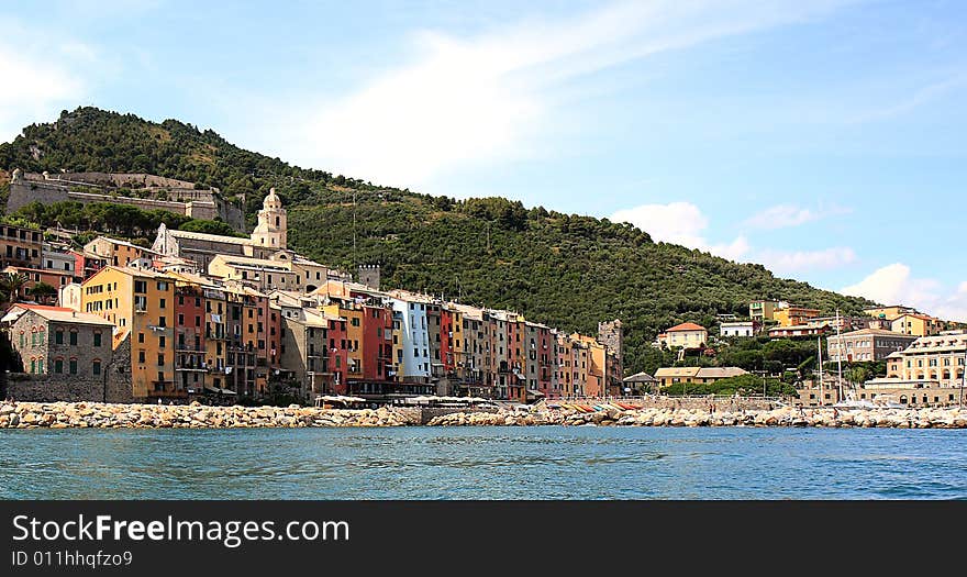 Fishing boats on a harbor with the seafront view of Portovenere in Italy.