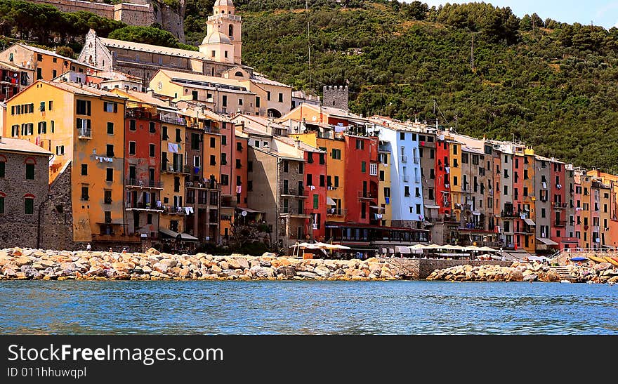 Fishing boats on a harbor with the seafront view of Portovenere in Italy.