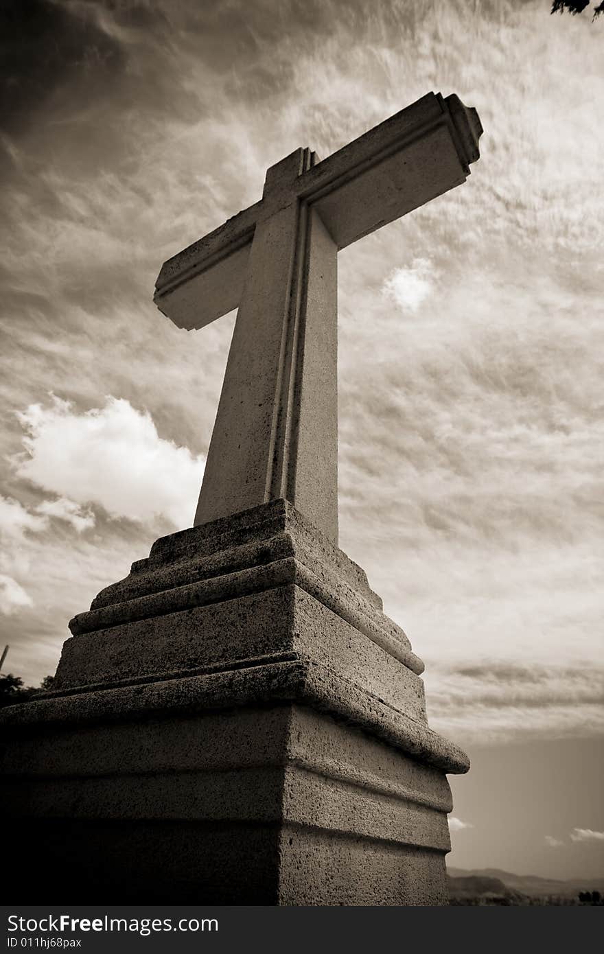 Christian stone cross under blue sky