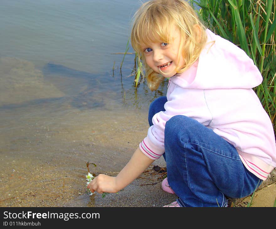 Little girl on the riverside.