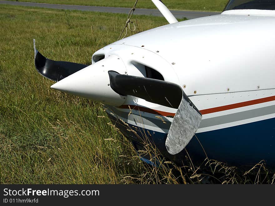 Front of a private airplane with a severely damaged propeller. Front of a private airplane with a severely damaged propeller