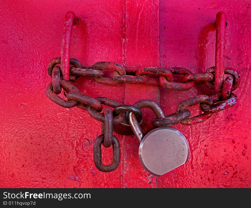 Rusty old chain and lock on lighthouse door. Rusty old chain and lock on lighthouse door.