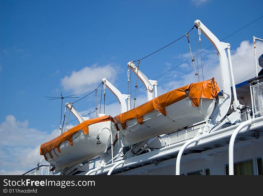 Two safe boats and blue sky with clouds. Two safe boats and blue sky with clouds