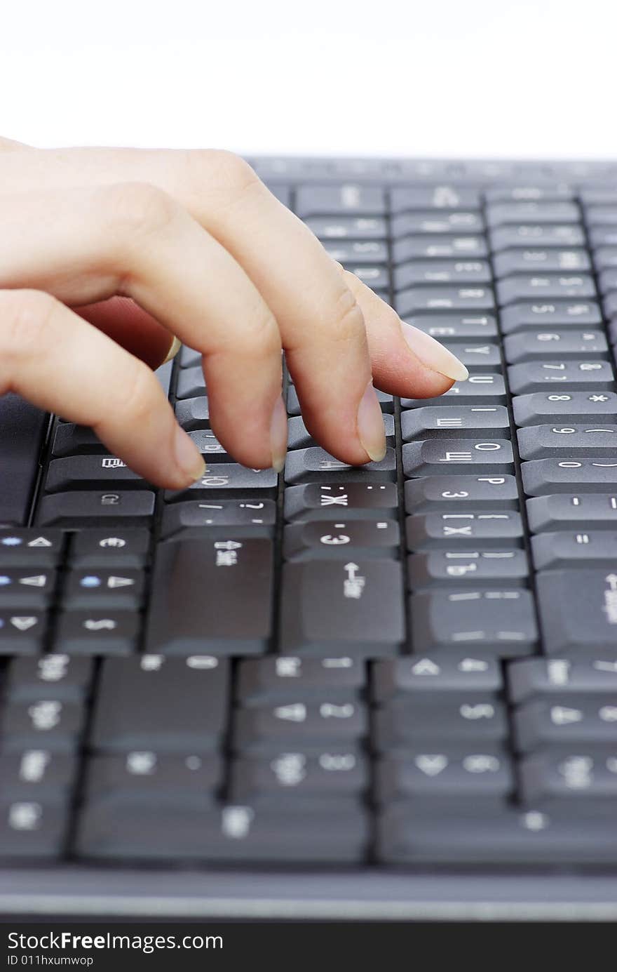 A womanish hand prints to the keyboard