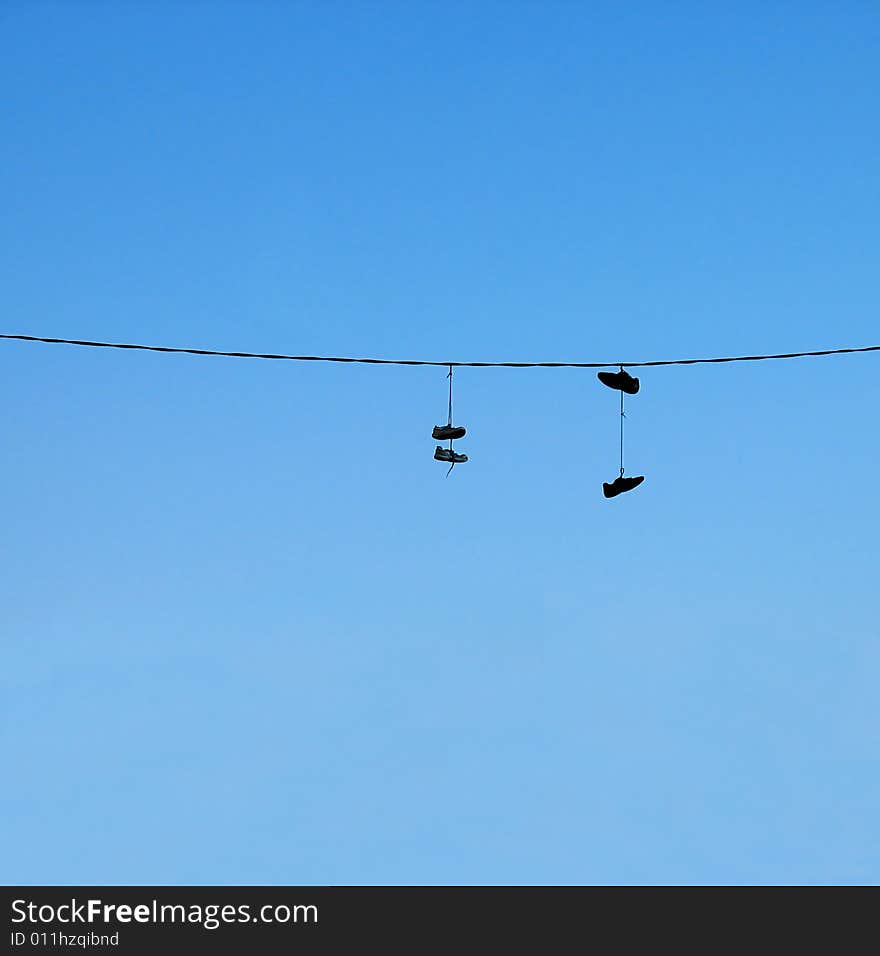 Hanging shoes over an electric line.