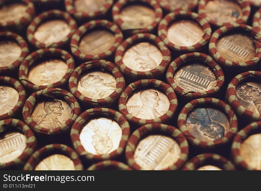 Photo of several rolls of pennies stacked up.