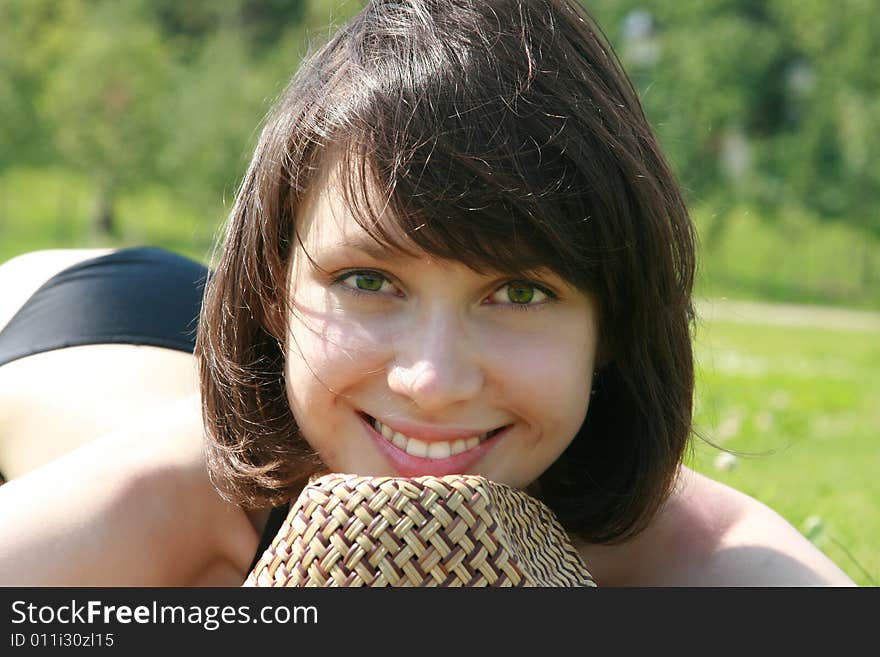 Portrait of a beauty smiling and laying on a grass