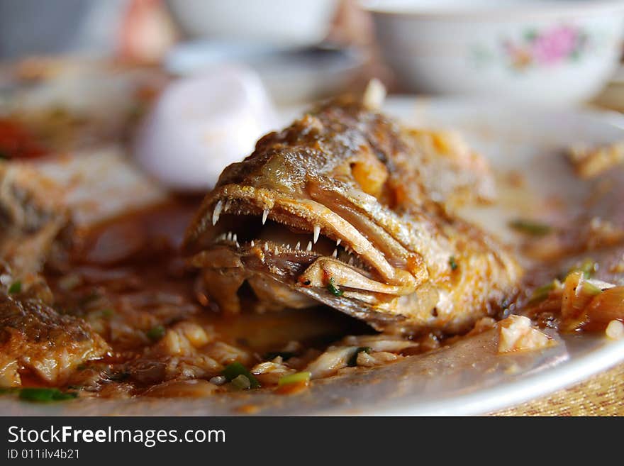 A lunch of whole fried fish on a junk boat in ha long bay, vietnam. A lunch of whole fried fish on a junk boat in ha long bay, vietnam