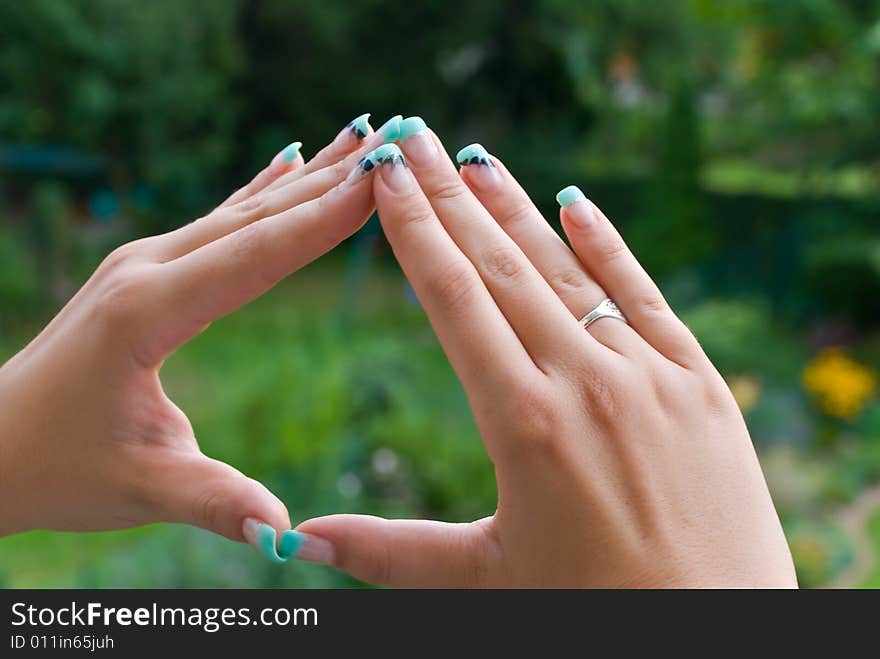 Fingernails of a woman in the nature