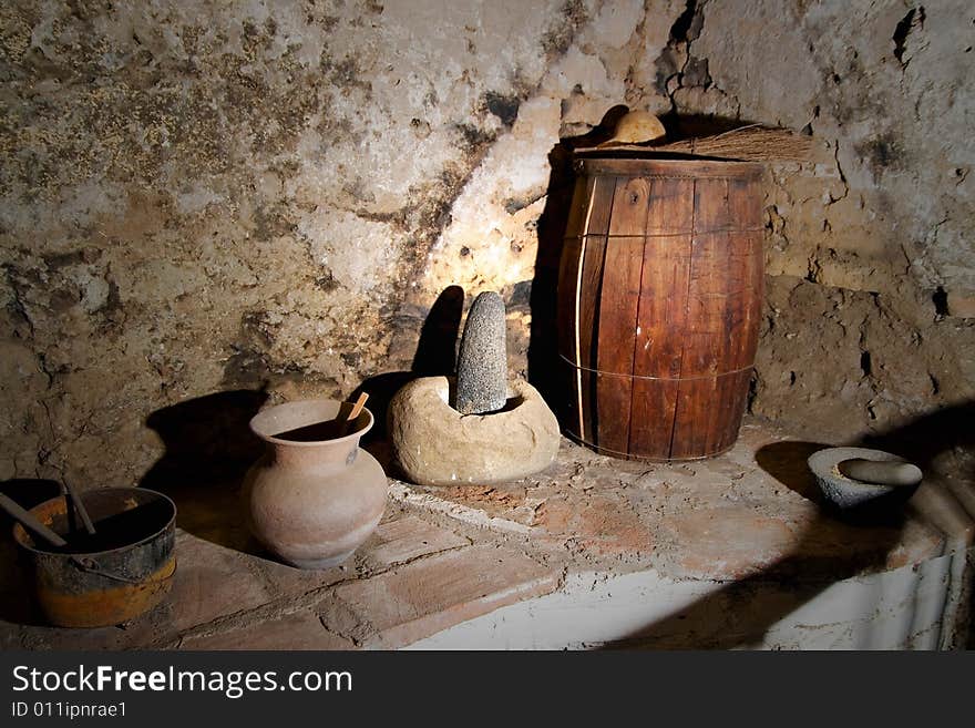 An old kitchenware made of clay and wood. An old kitchenware made of clay and wood