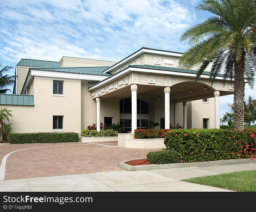 Hotel Drive Under Entrance with Green Palm Tree