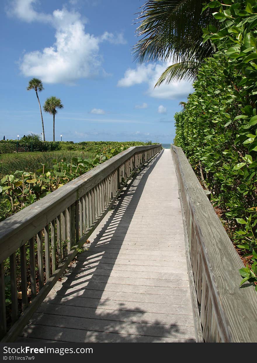 Wooden Walkway to Beach perspective blue sky