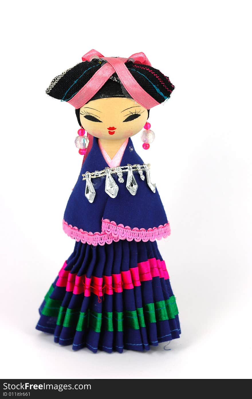 Chinese doll with ethnologic clothes on white background.