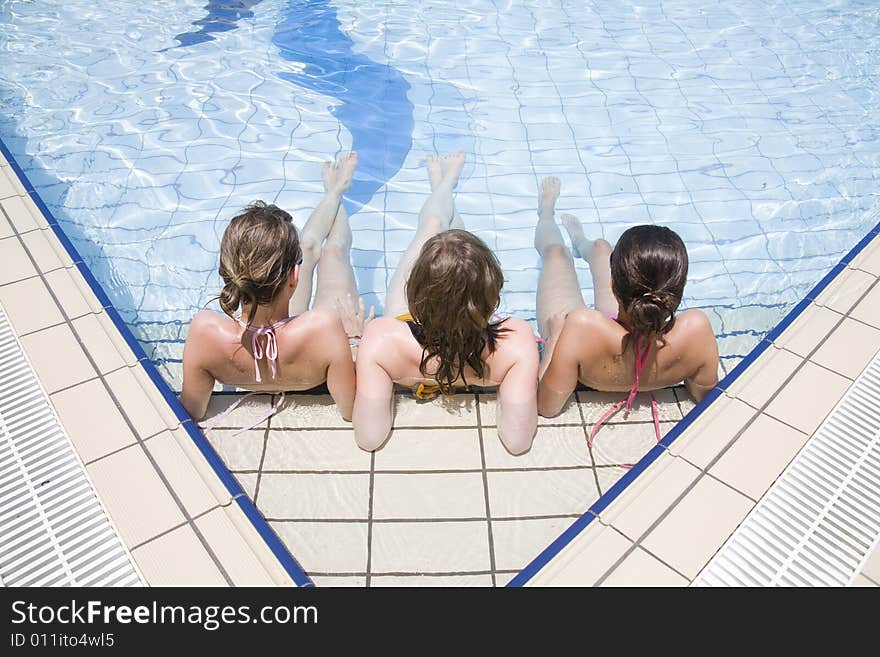 Teen girls sit in the water. Teen girls sit in the water