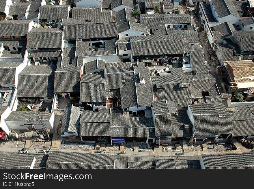 China, Zhejiang province, Shaoxing - residential area in old part of town, small houses with black roofs. China, Zhejiang province, Shaoxing - residential area in old part of town, small houses with black roofs.