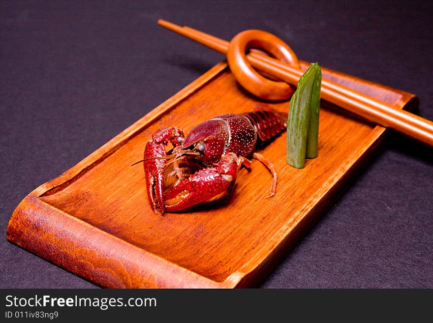 Seafood crawdads with shells in a wooden plate. Seafood crawdads with shells in a wooden plate.