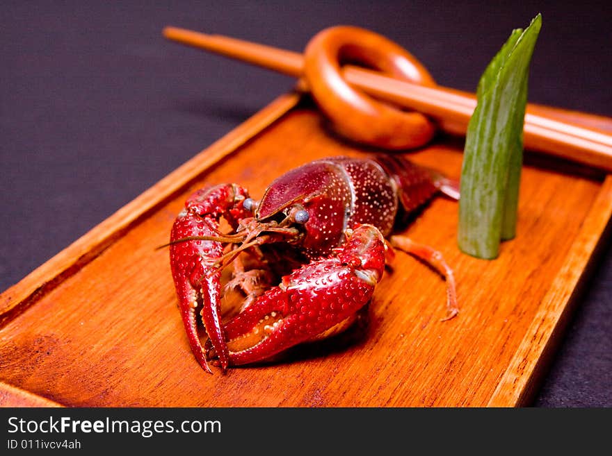 Seafood crawdads with shells in a wooden plate. Seafood crawdads with shells in a wooden plate.