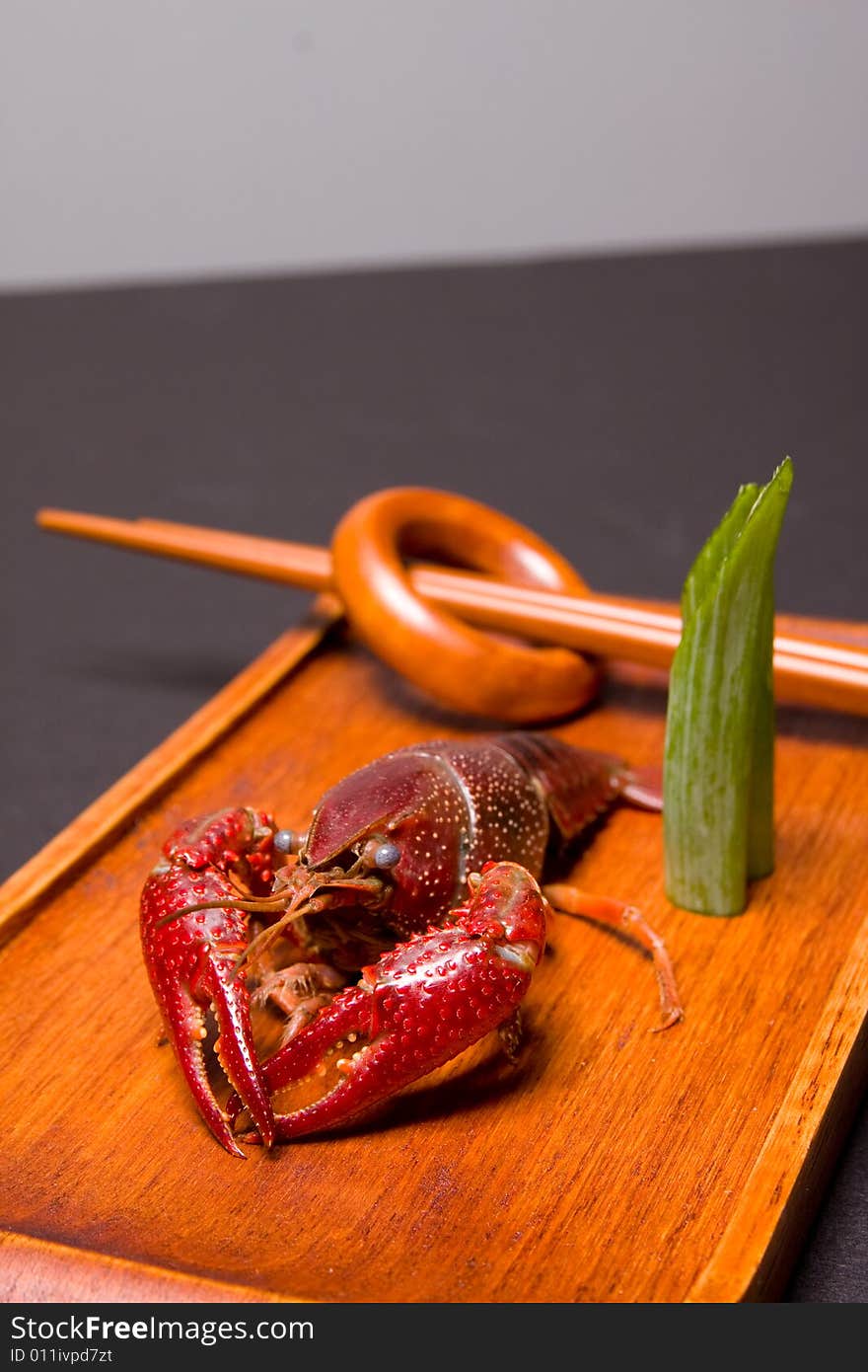 Seafood crawdads with shells in a wooden plate. Seafood crawdads with shells in a wooden plate.