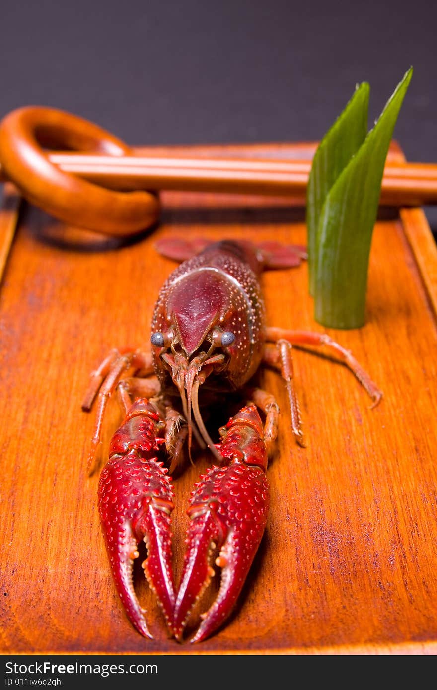 Seafood crawdads with shells in a wooden plate. Seafood crawdads with shells in a wooden plate.