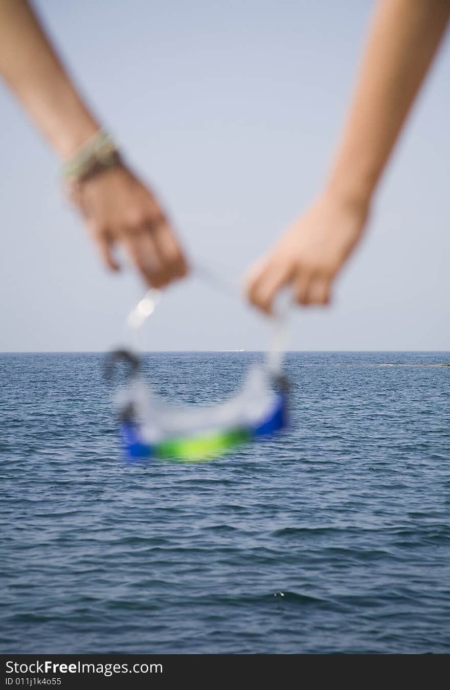 Dept of focus play with goggles and near sea. Dept of focus play with goggles and near sea