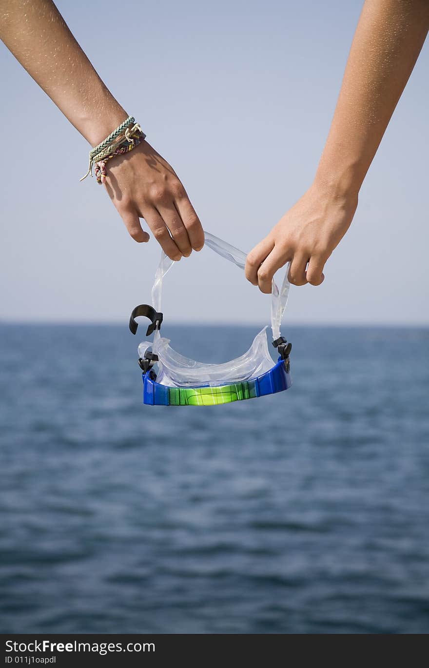 Dept of focus play with goggles and near sea. Dept of focus play with goggles and near sea