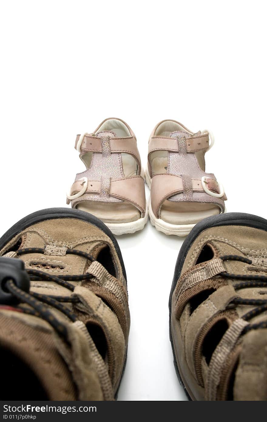 Big male and small baby walking sandals, isolated, on white background. Big male and small baby walking sandals, isolated, on white background