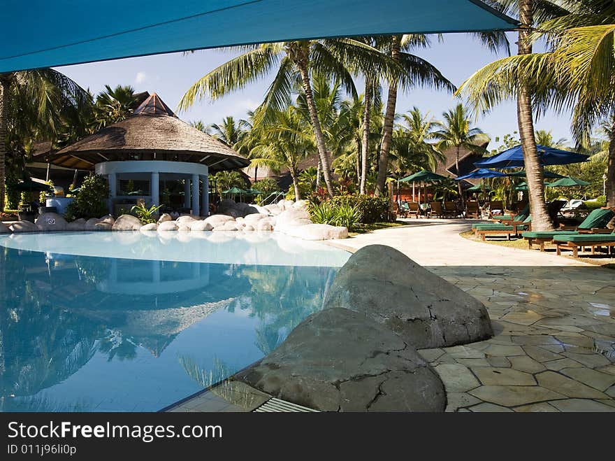 A shaded swimming pool at beach resort.