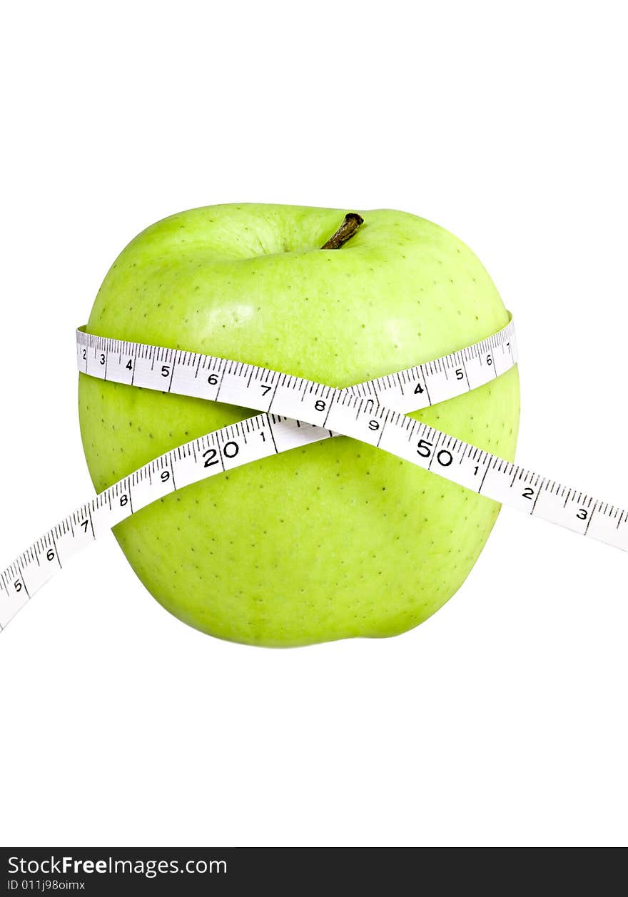 Delicious green apple with a measuring tape wrapped around it, isolated. Delicious green apple with a measuring tape wrapped around it, isolated