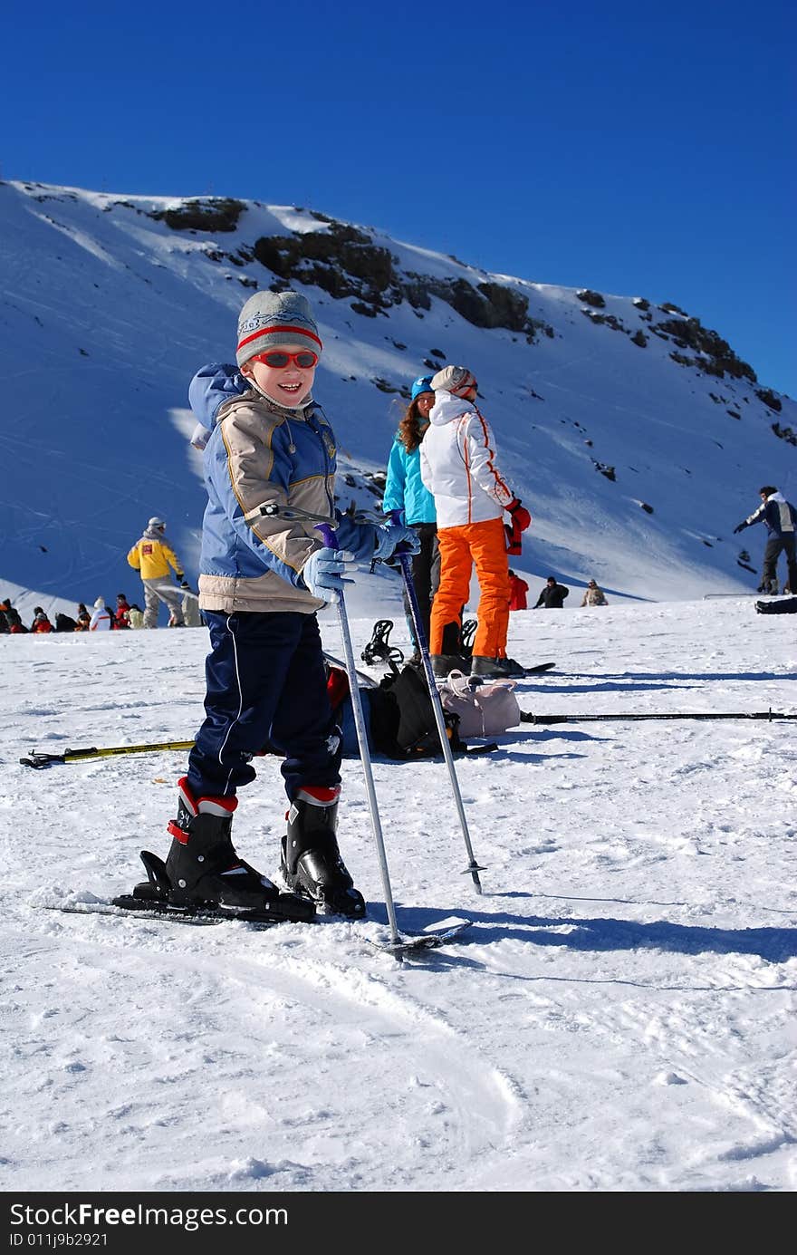 The boy in a cap plays a snow