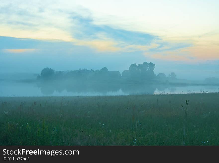 Fog lifts over the farm, lake and meadow. Fog lifts over the farm, lake and meadow.