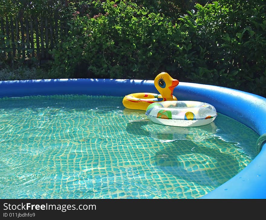 Waterpool with toys in the garden