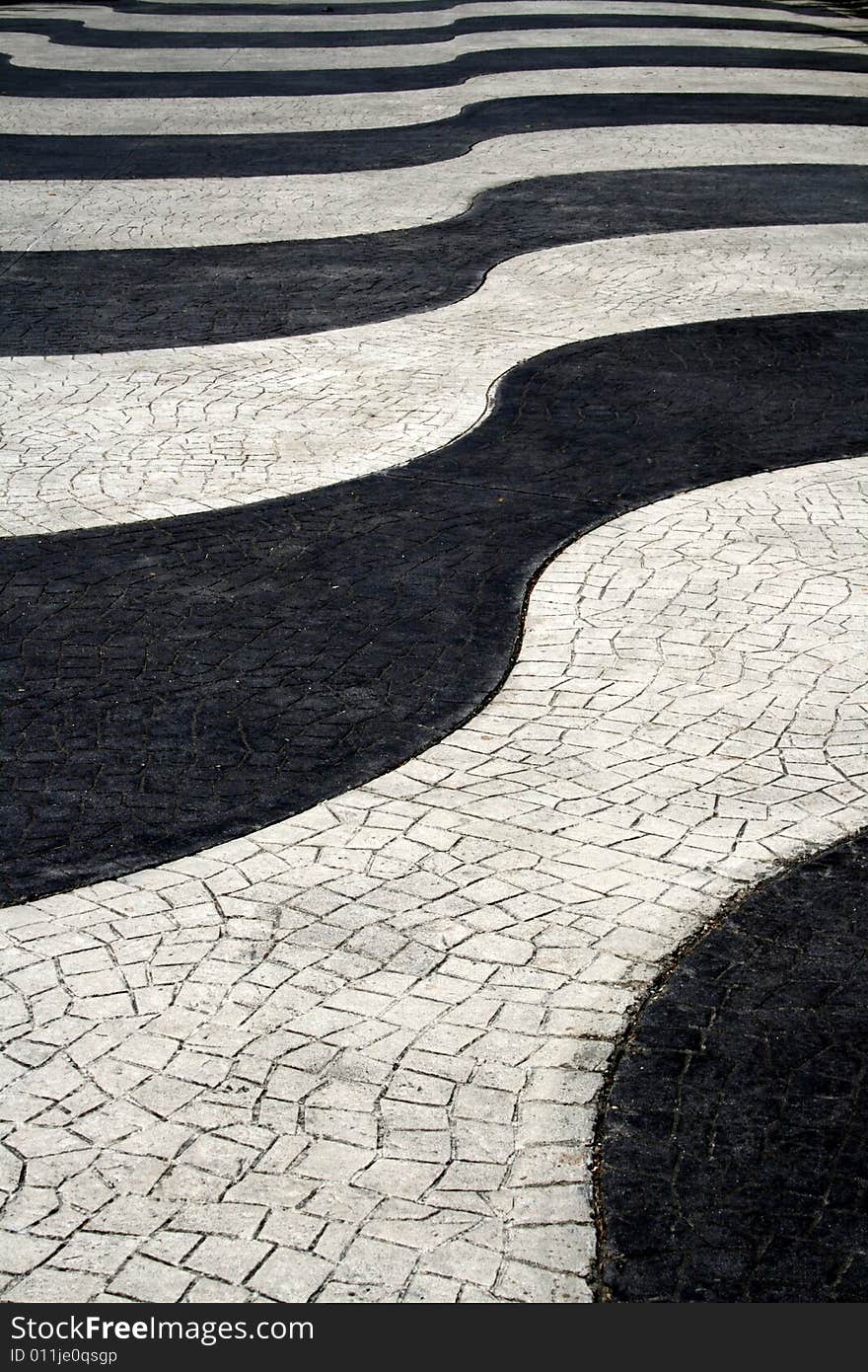 Wavy black and white paved roadway. Wavy black and white paved roadway