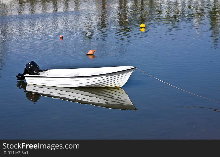 Small fishing boat with beautiful reflection.