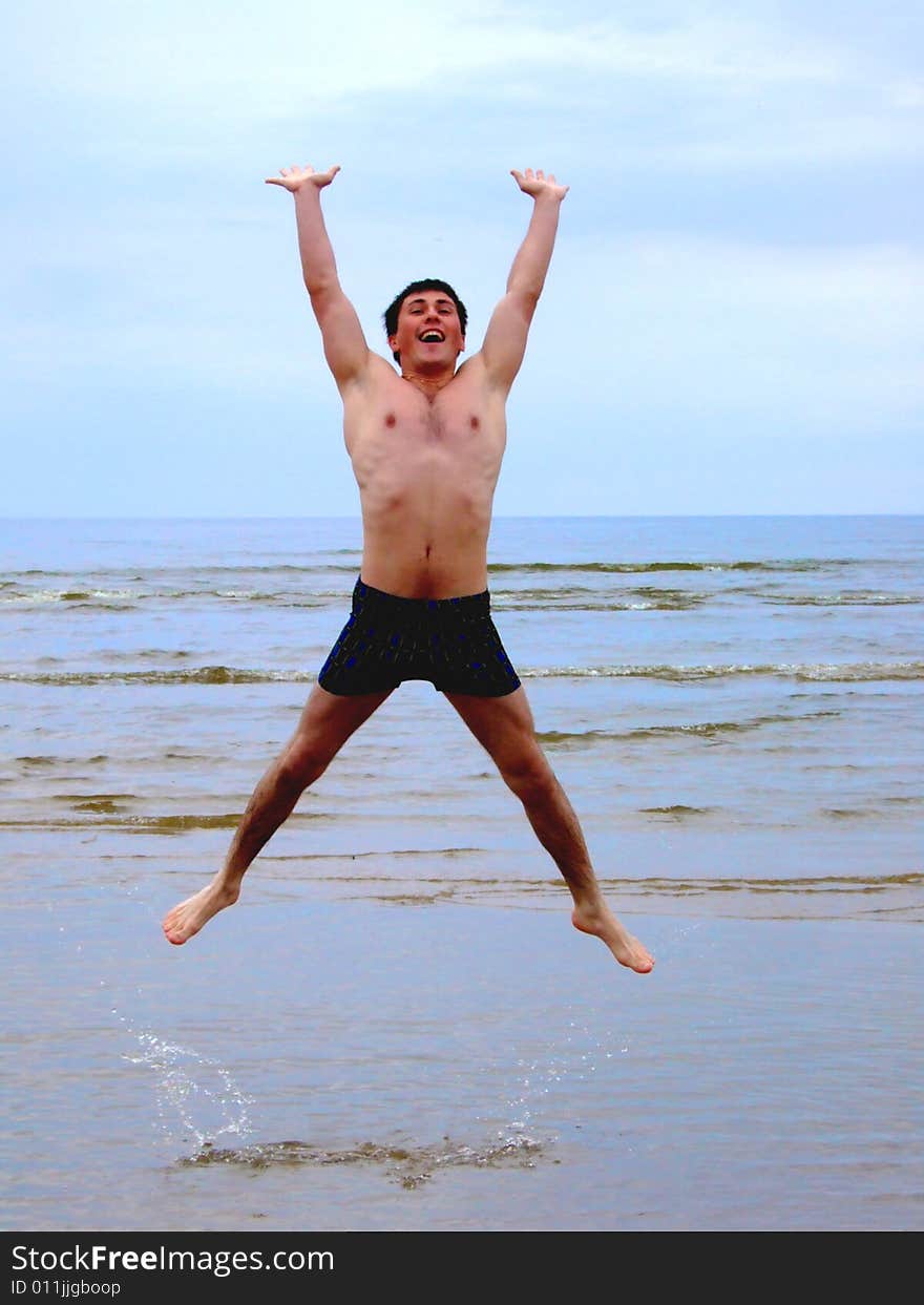 Man Jumping On Seacoast.