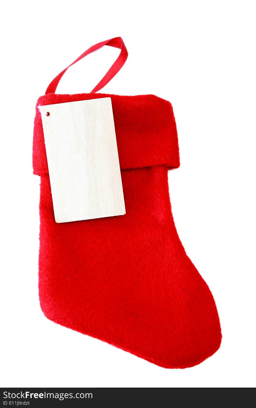 A red Christmas stocking with a blank name tag all isolated on a white background.