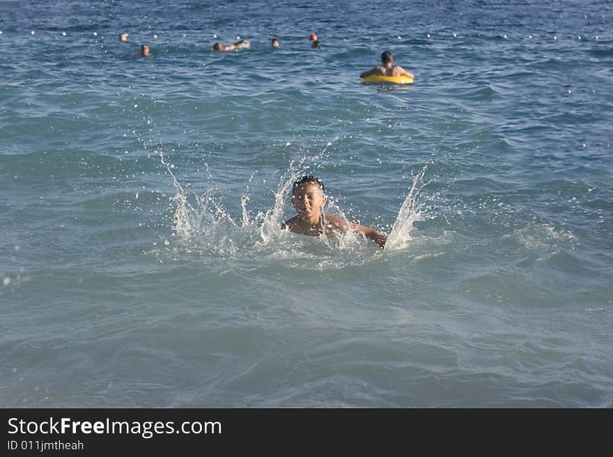 Happy boy playing in a water