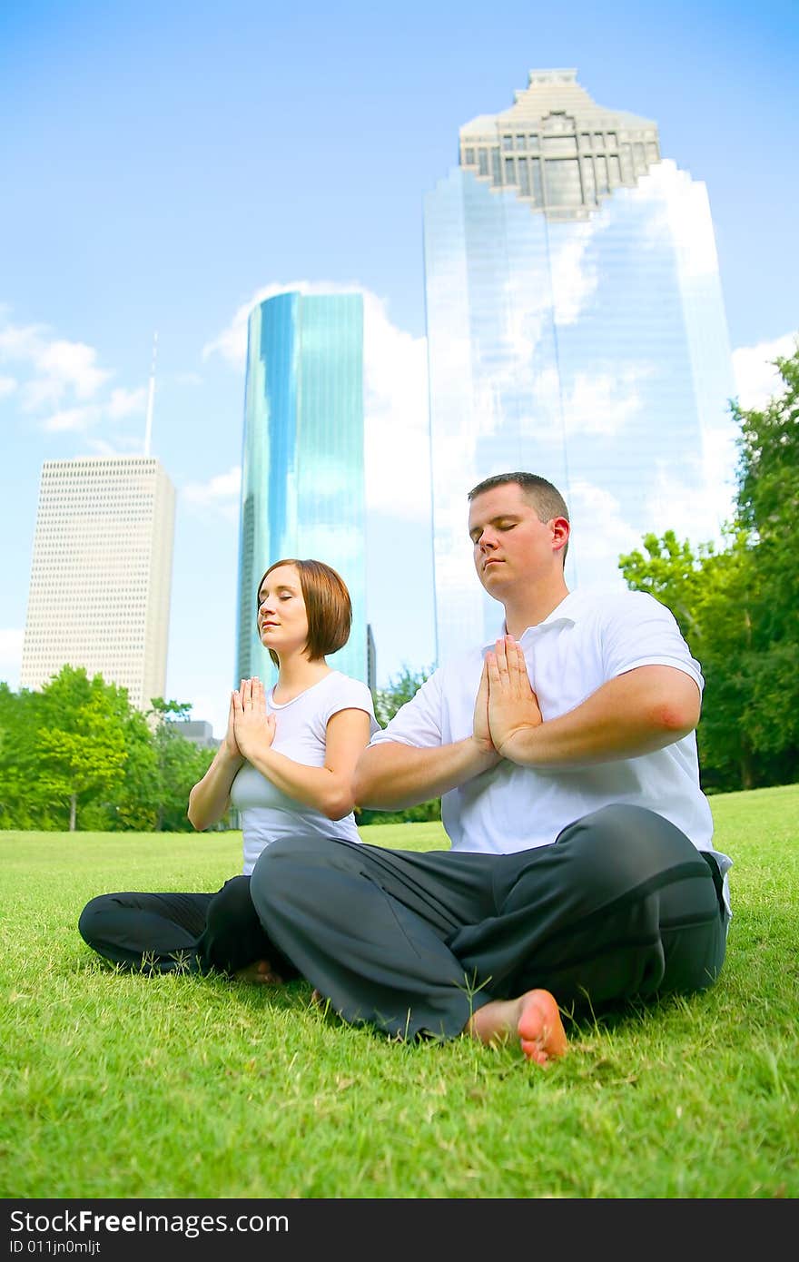 Couple Meditating In Downtown