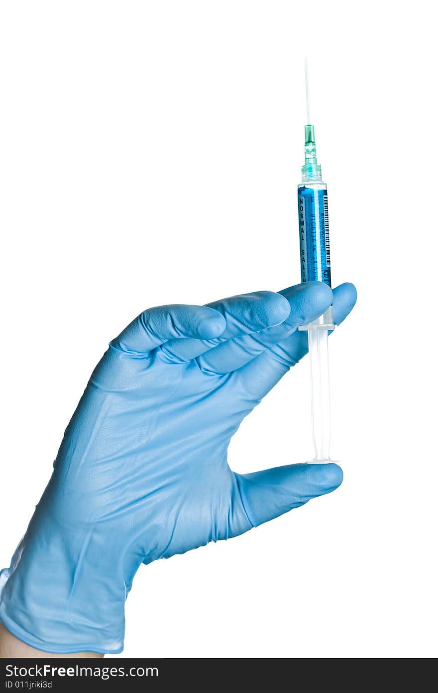 Hand in blue glove holding syringe on white background