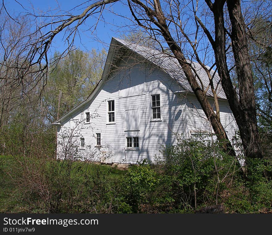 Barn surrounded by foliage & shrubbery. Barn surrounded by foliage & shrubbery.