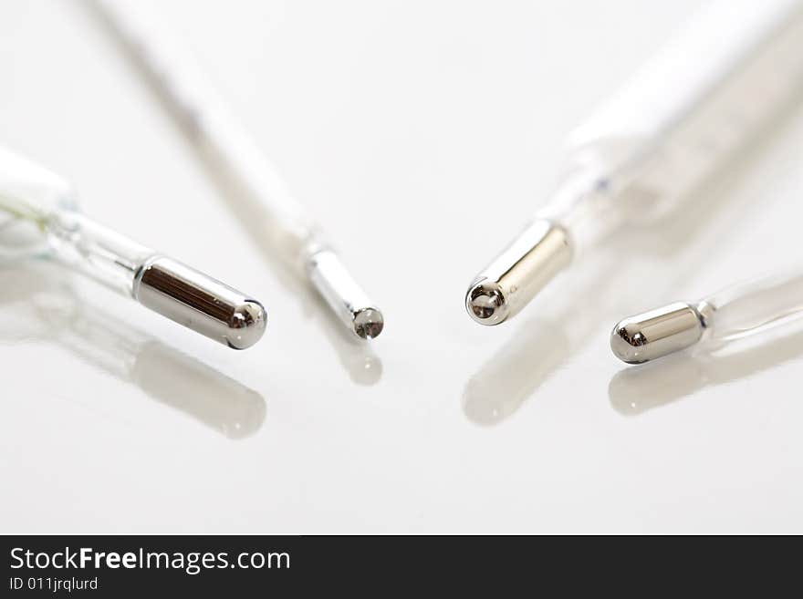 Medical mercury thermometers on white background