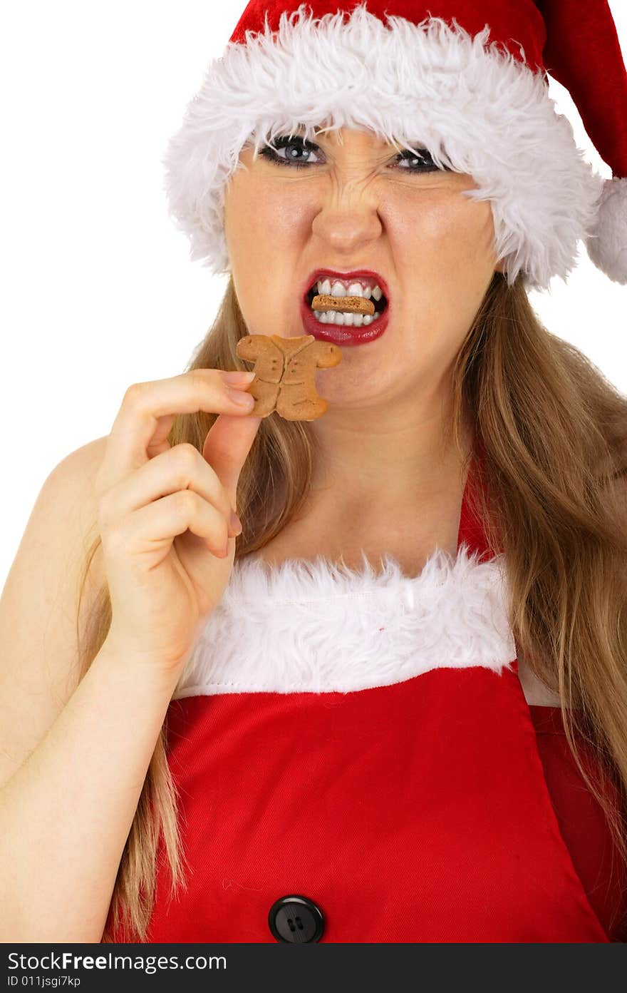 Mrs santa claus with angry expression and biting off gingerbread's head. Mrs santa claus with angry expression and biting off gingerbread's head