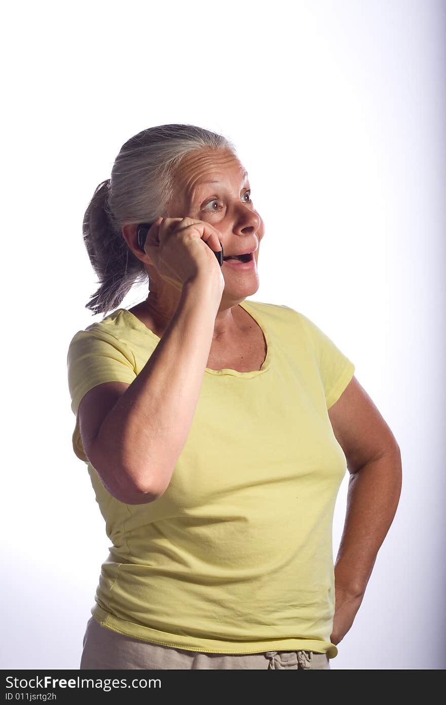 Senior woman on phone looking surprised and happy. Senior woman on phone looking surprised and happy