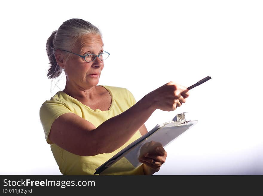 Senior woman marking clipboard,wearing glasses. Senior woman marking clipboard,wearing glasses