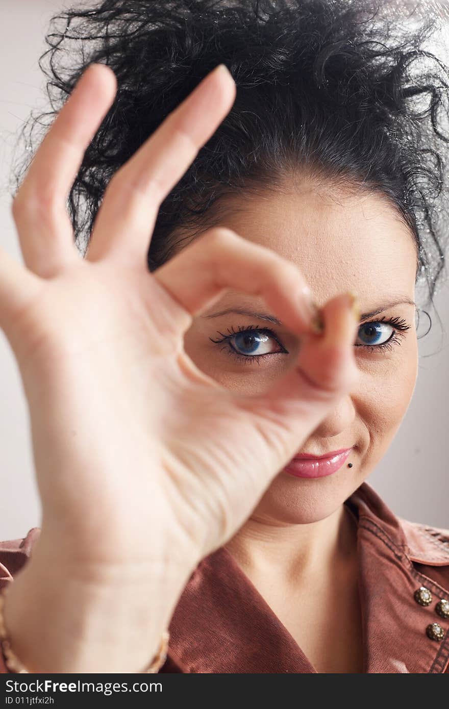 A girl shows a symbol of all well. A girl shows a symbol of all well