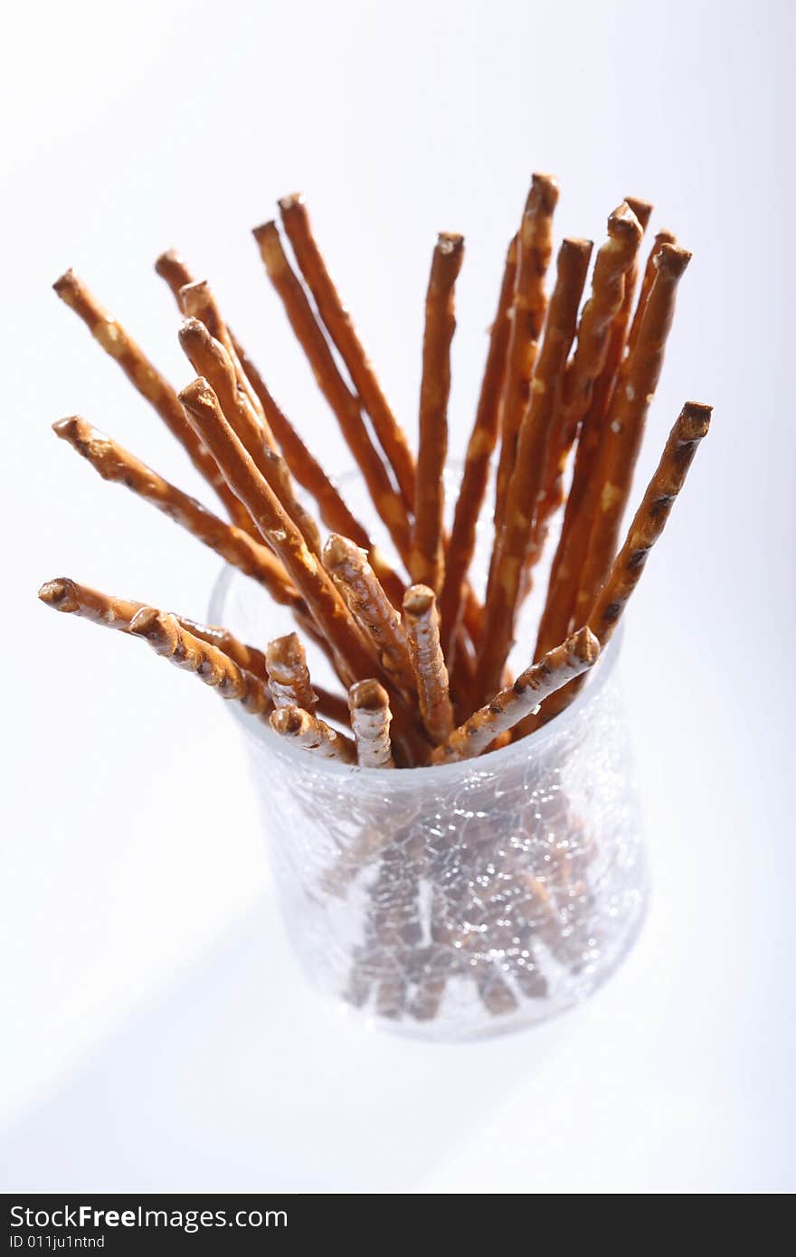 Saltsticks in a glass on white background