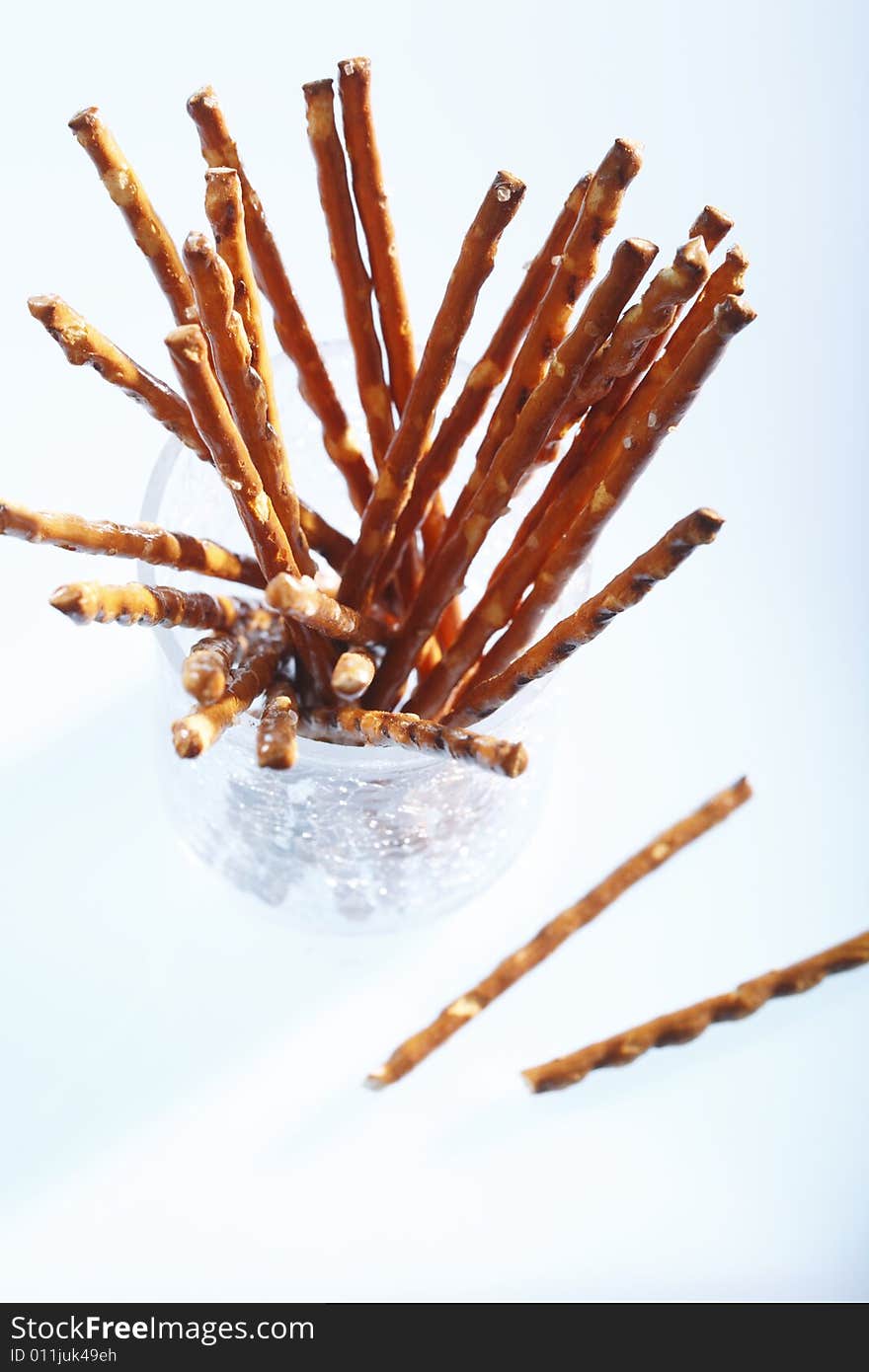 Saltsticks in a glass on white background