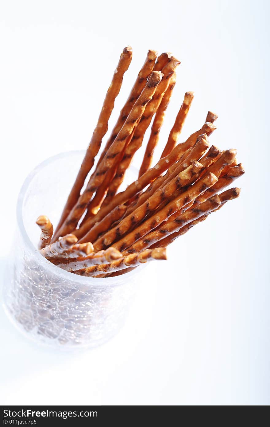 Saltsticks in a glass on white background