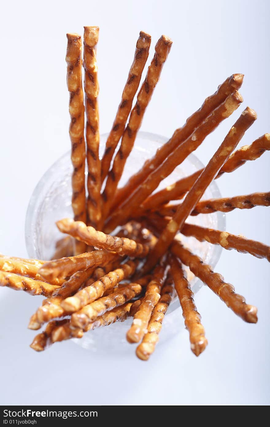 Saltsticks in a glass on white background